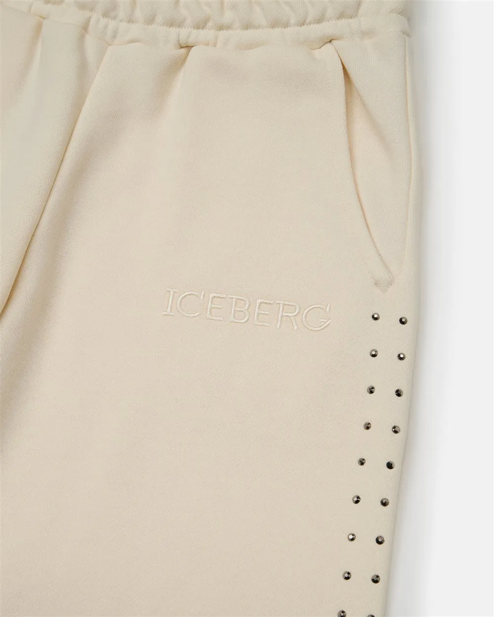 Pantaloni felpati modello joggers color panna con borchie